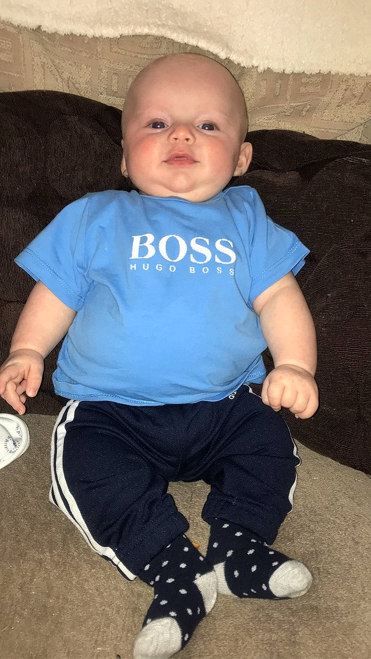 Riley is registered to the contest to win money with this photo: baby, baby_toddler_clothing, blue, cheek, child, cool, person, sitting, t_shirt, toddler