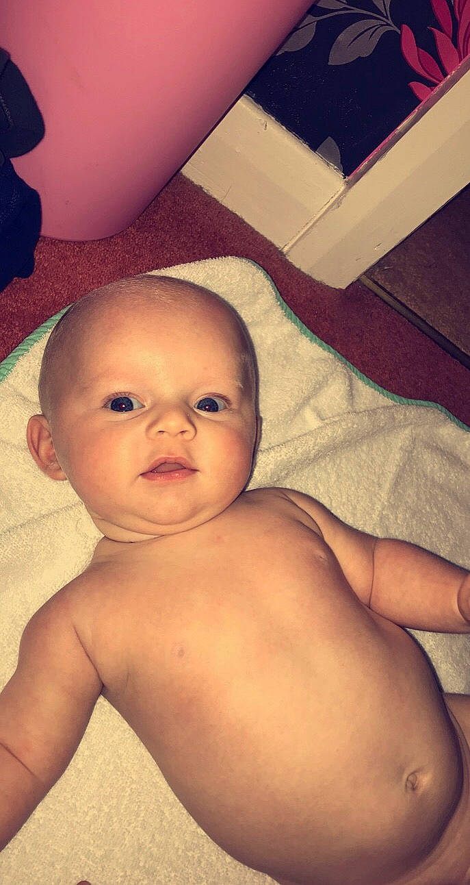 Riley is registered to the contest to win money with this photo: arm, baby, cheek, chest, child, chin, eye, eyebrow, face, forehead, head, lip, mouth, muscle, nose, organ, person, skin, stomach, toddler