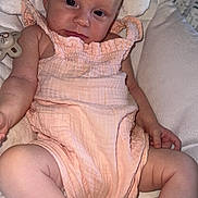 Liala joined the competition — help win amazing prizes! baby, infant, child, person, cushion, pacifier, clothing, soft, peach, white, seat, relaxed, cute, skin, legs, arms, face, eyes, indoors, portrait