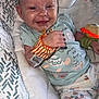 baby, smiling, infant, cushion, clothing, wrist_rattle, turtle, patterned_pants, seat, happy, cute, child, indoor, soft, toy, person, portrait, baby_garment, newborn, comfortable