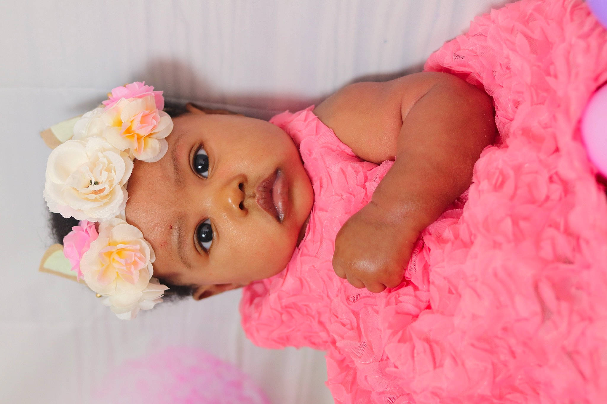 Norielle joined the competition — help win amazing prizes! baby, baby_toddler_clothing, cheek, chin, dress, eye, eyebrow, face, facial_expression, flower, happy, headgear, headpiece, headwear, lip, nose, person, petal, pink, skin