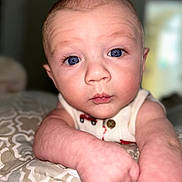 Kendall joined the competition — help win amazing prizes! baby, blue_eyes, close_up, curious, face, infant, patterned_blanket, pale_skin, portrait, reaching_out, resting_arms, soft_background, toddler, young_child, wearing_clothing, indoor, expression, chubby_arms, head, skin_texture