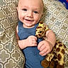 Kendall joined the competition — help win amazing prizes! baby, child, smiling, blue_eyes, plush_toy, giraffe, cushion, patterned, knit_clothing, portrait, indoor, happy, cute, infant, hand, face, person, seated, soft_toy, cozy