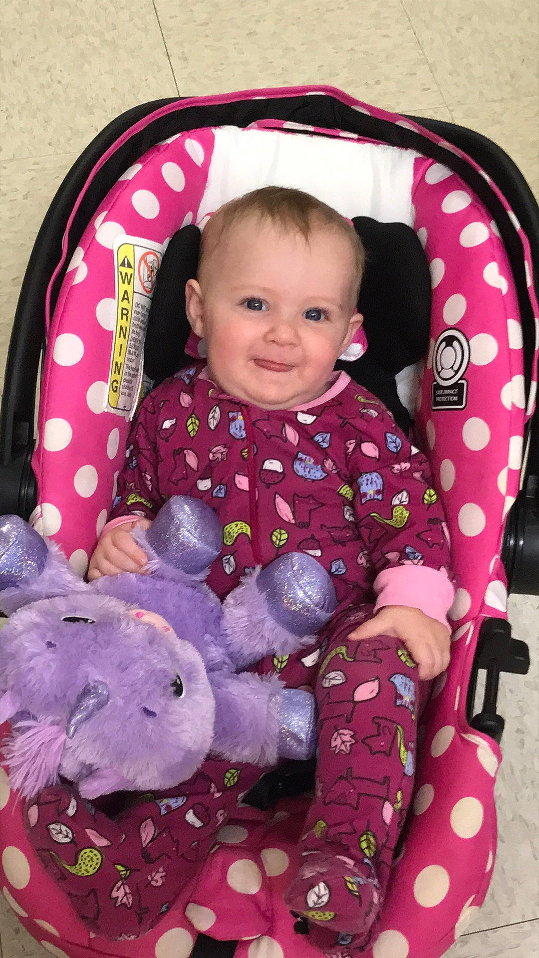 Kinzlee joined the competition — help win amazing prizes! baby, baby_carriage, baby_toddler_clothing, cheek, clothing, comfort, face, facial_expression, head, joy, organ, outerwear, person, pink, product, purple, skin, sleeve, smile, textile