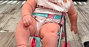 Avery joined the competition — help win amazing prizes! baby, child, stroller, pink, happy, smiling, indoors, flooring, wooden_floor, footwear, playful, cute, infant, person, seat, toy, expression, sitting, joyful, room