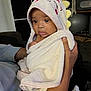 Vivienne is registered to the contest to win money with this photo: baby, towel, hood, dinosaur, spikes, hands, indoor, person, child, soft, blanket, curious, face, expression, cozy, clothing, infant, wrapped, caring, holding