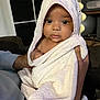 Vivienne joined the competition — help win amazing prizes! baby, towel, hood, dinosaur, child, indoor, person, skin, face, eyes, hand, holding, blanket, cute, soft, expression, infant, portrait, warm, comfort