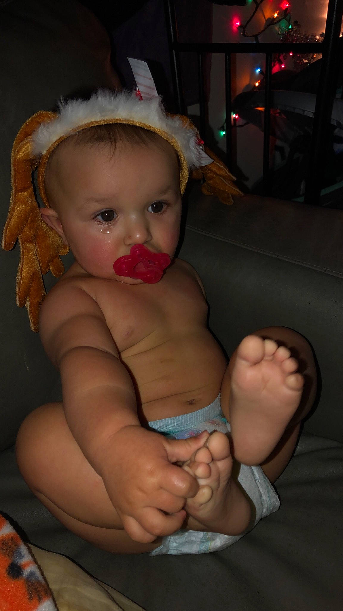 Donavan is registered to the contest to win money with this photo: abdomen, arm, cheek, child, finger, fun, girl, hand, human_hair_color, infant, lap, leg, mouth, organ, person, product, sitting, skin, toddler