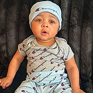 Chakhai joined the competition — help win amazing prizes! baby, brand, casual, champion, child, clothing, expression, eyes, face, furry_background, hand, hat, indoor, infant, logo, onesie, pants, portrait, sitting, texture
