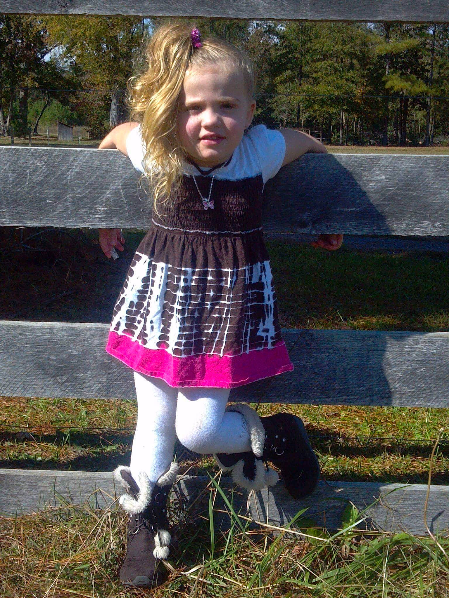 Katelyn Rose is registered to the contest to win money with this photo: child, child_model, design, dress, grass, leg, leggings, pattern, person, pink, plaid, plant, tartan, textile, tights, toddler, tree