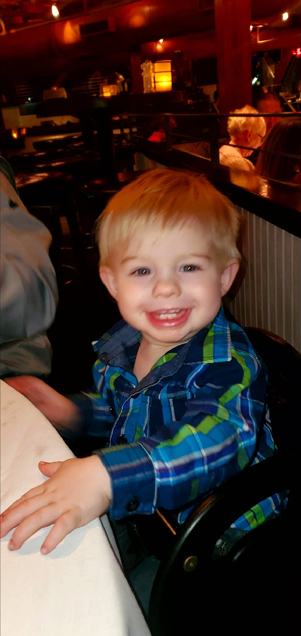 Leland is registered to the contest to win money with this photo: chair, cheek, child, event, fun, hairstyle, happy, holiday, iris, joy, pattern, person, plaid, room, sitting, smile, standing, t_shirt, tartan, toddler