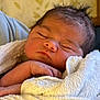 Maela is registered to the contest to win money with this photo: baby, newborn, sleeping, towel, hand, face, skin, hair, indoors, closeup, peaceful, resting, infant, child, soft, warm, blanket, portrait, cozy, wrapped
