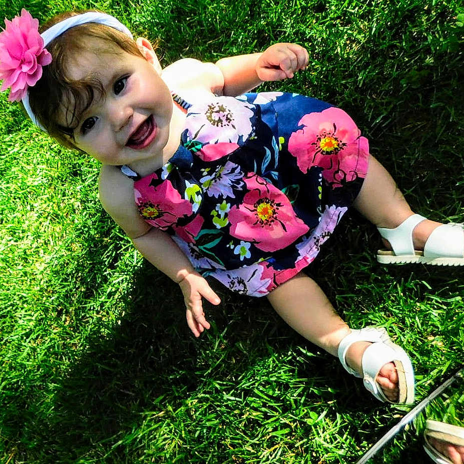 Journey is registered to the contest to win money with this photo: baby, backyard, clothing, dress, face, footwear, grass, head, lawn, nature, outdoors, park, person, photography, plant, portrait, sandal, shoe, summer, yard