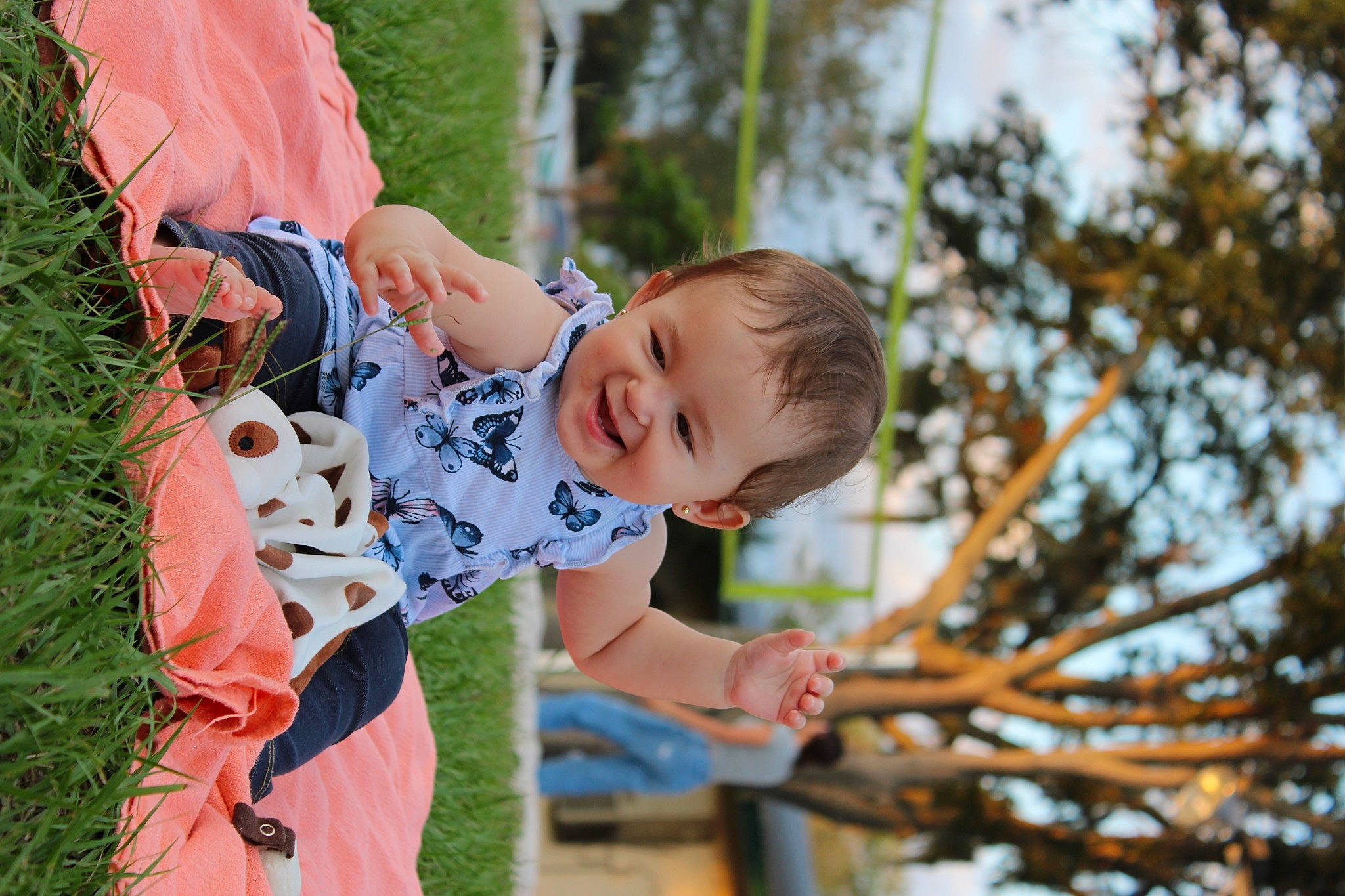 Lana is registered to the contest to win money with this photo: baby, child, event, fun, grass, happy, joy, leaf, leisure, people_in_nature, person, plant, play, recreation, sitting, sky, smile, toddler, tree, vacation