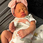 Gabriella joined the competition — help win amazing prizes! newborn, baby, infant, sleeping, headband, pink, onesie, animal_print, blanket, cozy, cute, small_hands, small_feet, closed_eyes, soft_lighting, indoors, portrait, child, peaceful, resting