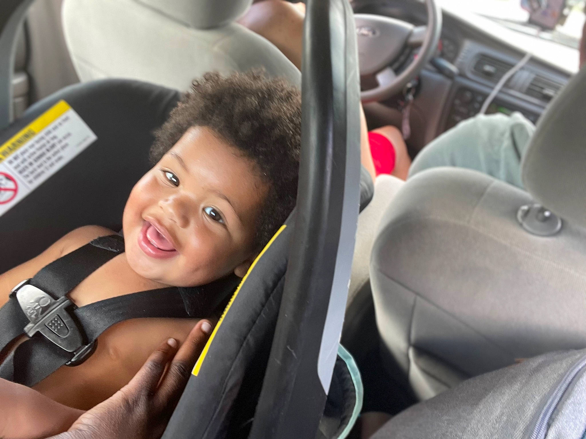 Carter is registered to the contest to win money with this photo: auto_part, automotive_design, automotive_exterior, automotive_wheel_system, car, car_seat, car_seat_cover, comfort, family_car, head_restraint, luxury_vehicle, motor_vehicle, person, personal_luxury_car, seat_belt, smile, steering_part, steering_wheel, toddler, vehicle