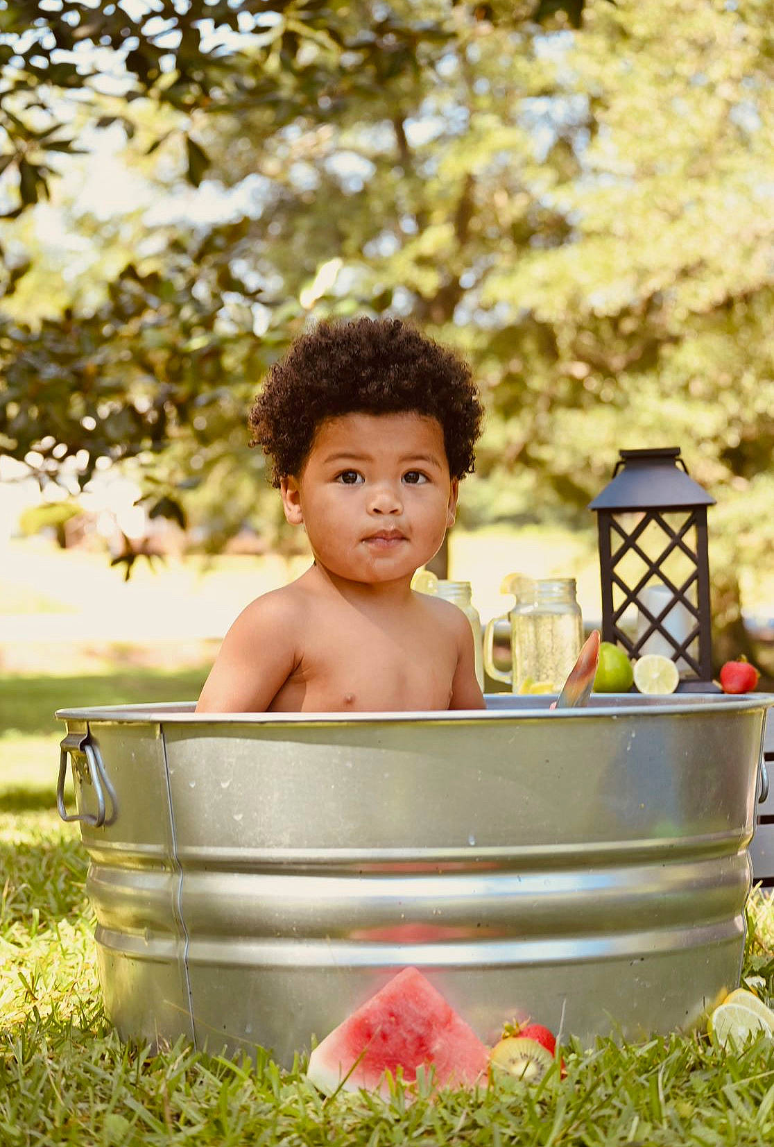 Carter is registered to the contest to win money with this photo: baby, bathing, child, fun, grass, happy, leaf, leisure, people_in_nature, person, photograph, plant, play, portrait_photography, recreation, sitting, spring, summer, sunlight, toddler
