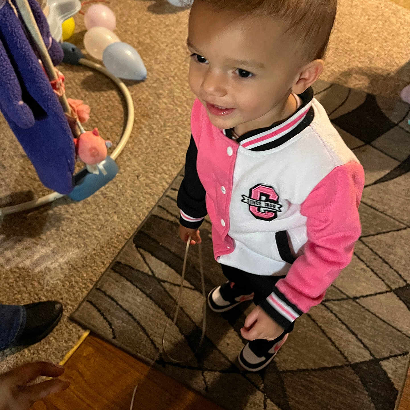Lamonnie is registered to the contest to win money with this photo: baby, balloon, bodypart, child, clothing, face, female, finger, footwear, girl, hand, hardwood, head, indoors, interiordesign, person, photography, portrait, shoe, wood