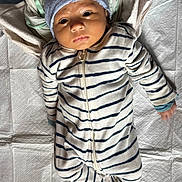 Arita joined the competition — help win amazing prizes! baby, infant, striped_clothing, onesie, hat, blanket, fabric, lying_down, face, newborn, child, soft_lighting, indoors, sleepwear, portrait, cute, small_hands, head_covering, curious_expression, baby_gaze