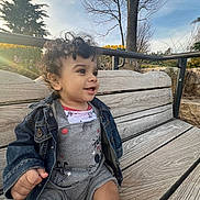 Jayce is registered to the contest to win money with this photo: bench, clothing, coat, face, furniture, grass, head, jacket, jeans, nature, outdoors, pants, park, person, photography, plant, portrait, sitting, tree, wood