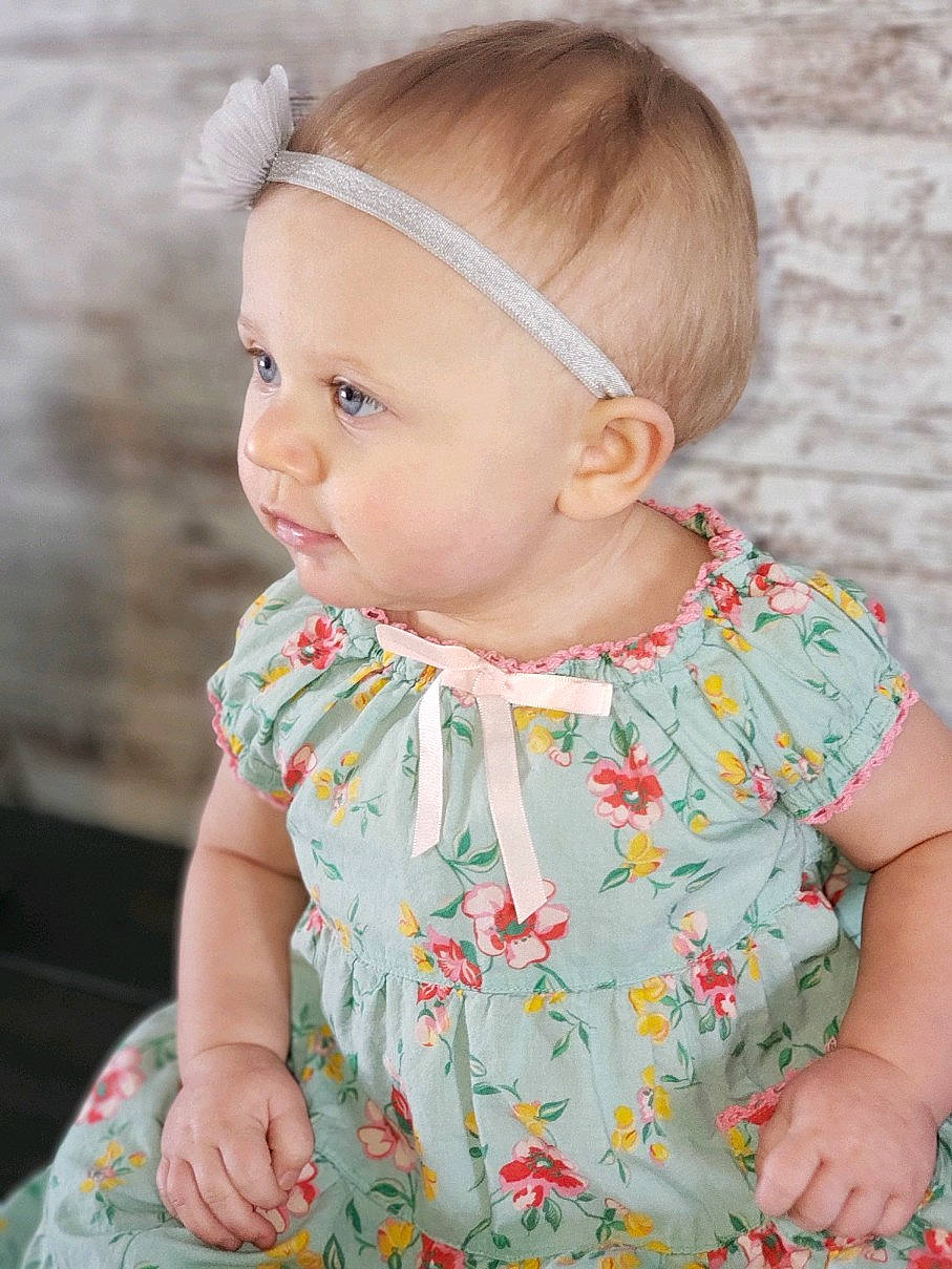Harper joined the competition — help win amazing prizes! baby, baby_toddler_clothing, cheek, child, clothing, design, dress, ear, fashion_accessory, hair_accessory, head, headband, headgear, pattern, person, product, skin, textile, toddler, yellow
