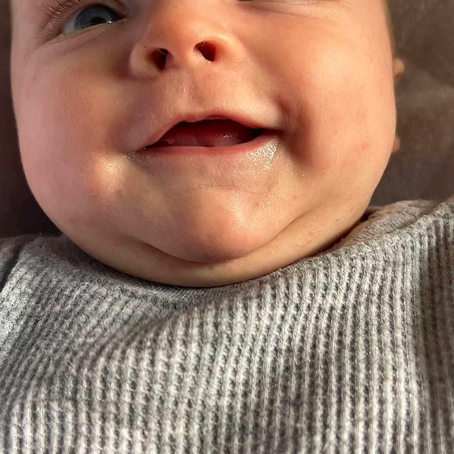 Grayson is registered to the contest to win money with this photo: baby, babylaughing, blonde, bodypart, clothing, face, hair, happy, head, knitwear, laughing, mouth, newborn, person, photography, portrait, selfie, smile, sweater, teeth