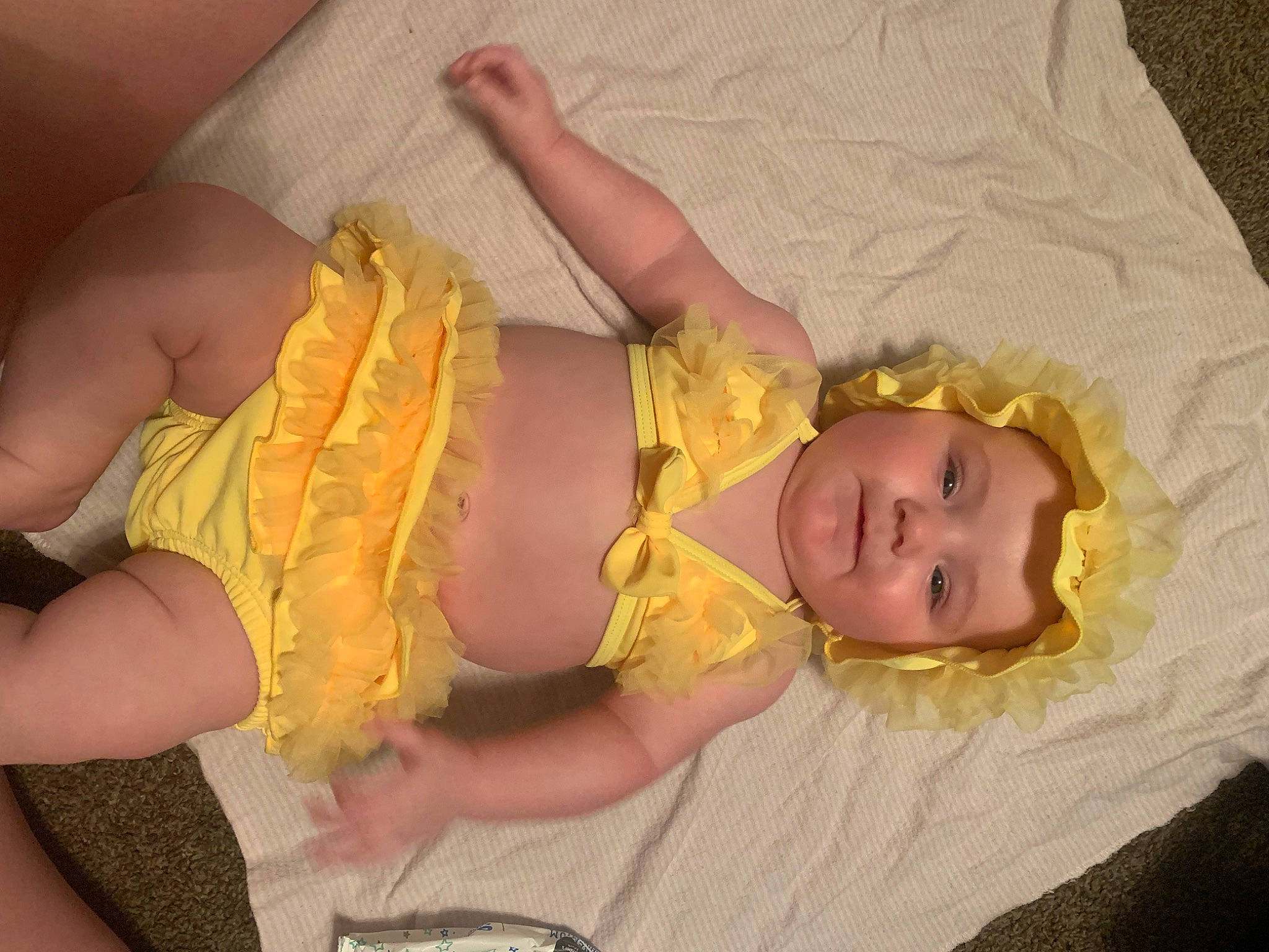 Nyomi is registered to the contest to win money with this photo: abdomen, baby, baby_products, baby_toddler_clothing, child, comfort, dress, finger, fun, hand, happy, head, human_body, pattern, person, pink, product, skin, textile, thumb