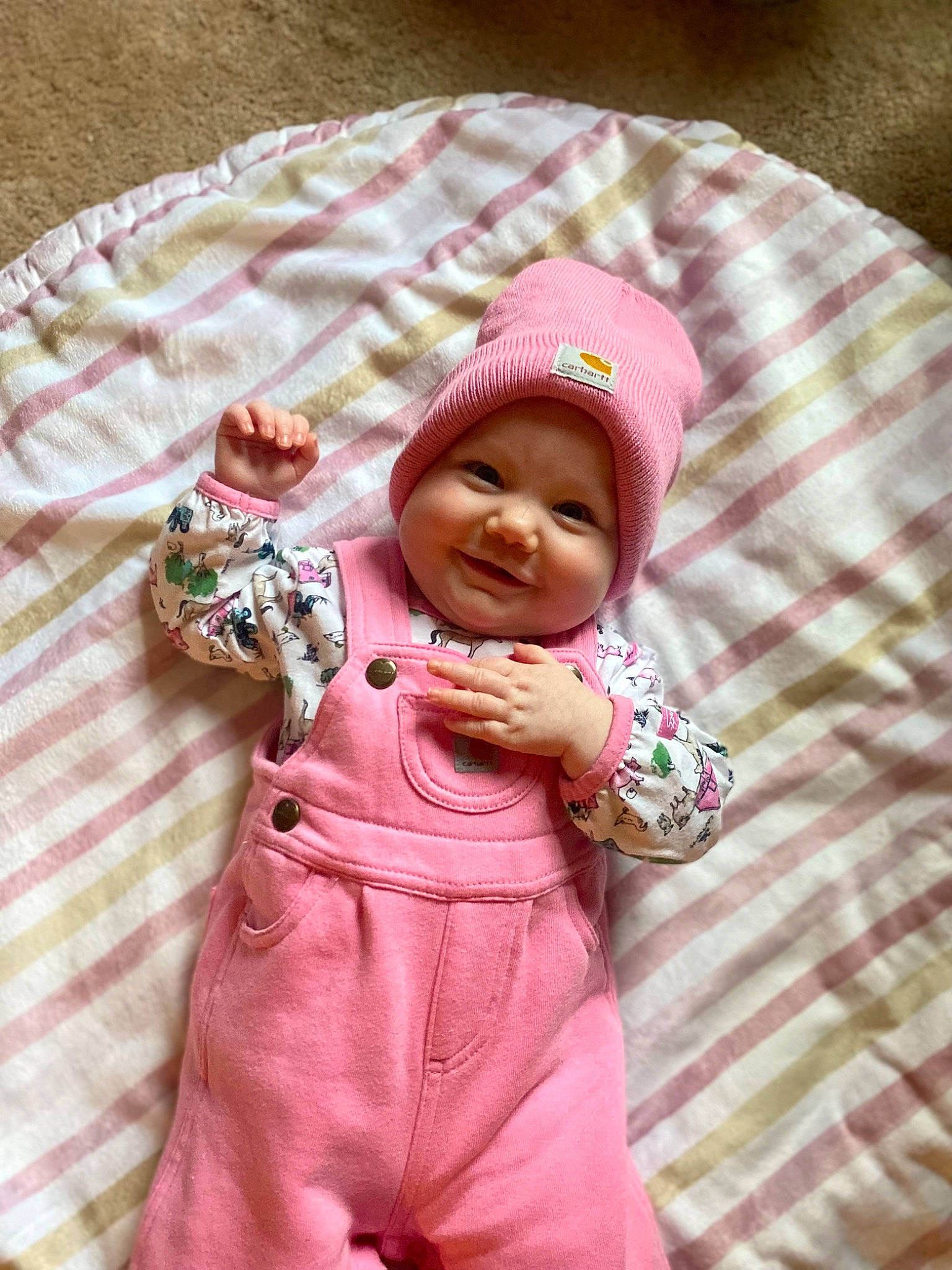 Emberly is registered to the contest to win money with this photo: baby, baby_toddler_clothing, beanie, cap, cheek, child, comfort, face, happy, head, headgear, headwear, joy, knit_cap, linens, magenta, pattern, person, pink, skin