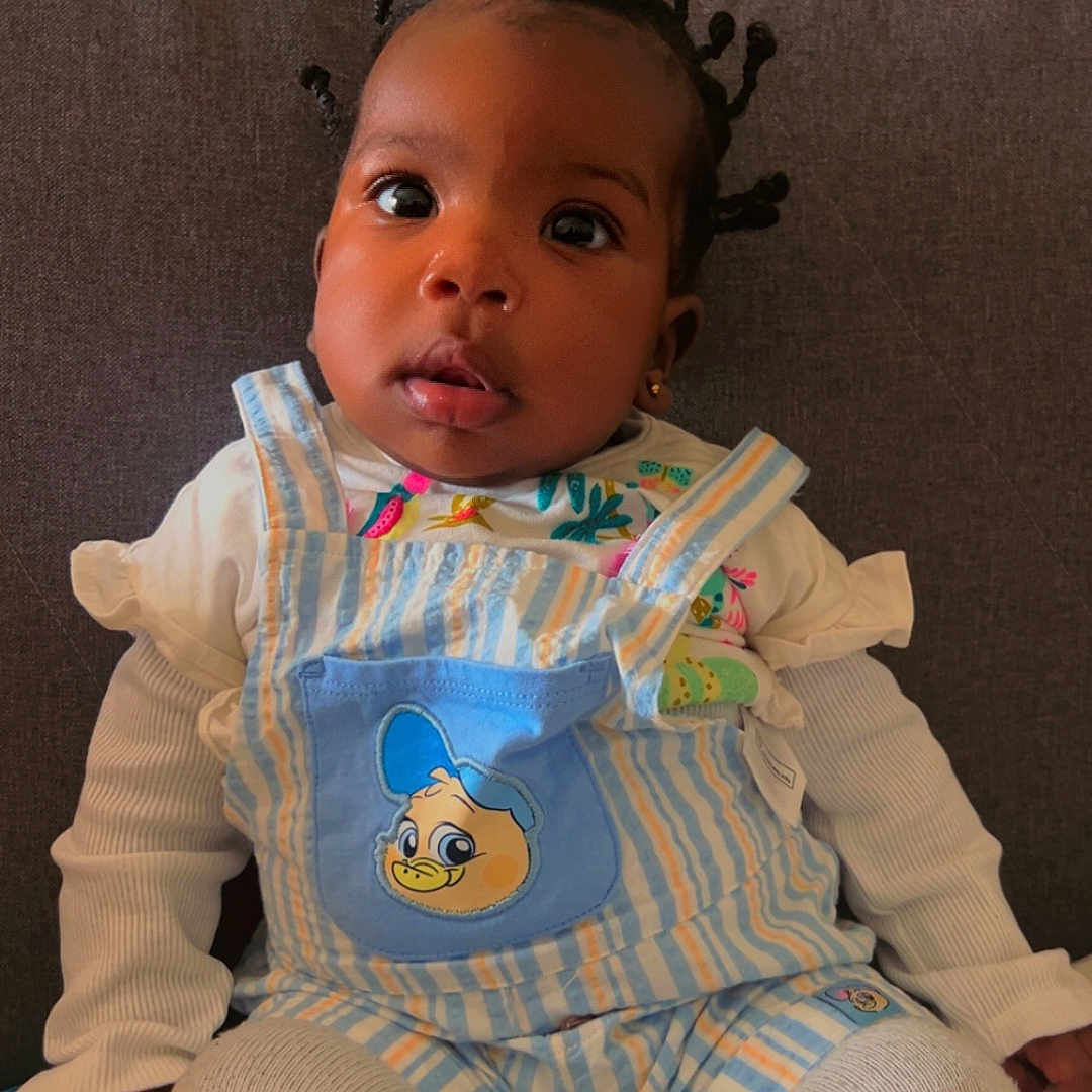 Axelle joined the competition — help win amazing prizes! baby, bonnet, clothing, couch, crib, cushion, doll, face, furniture, hat, head, homedecor, infantbed, linen, pants, person, photography, portrait, sitting, toy