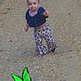 animal, black_top, butterfly, child, colorful, cute, gravel, green, hair_pigtails, leopard_print, nature, outdoor, pants, path, person, playful, small, summer, toddler, walking