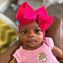 baby, infant, pink_bow, headband, pink_onesie, sassy_and_sweet, close_up, portrait, cute, child, human, indoor, soft_focus, expression, looking_at_camera, skin, small_person, newborn, adorable, clothing