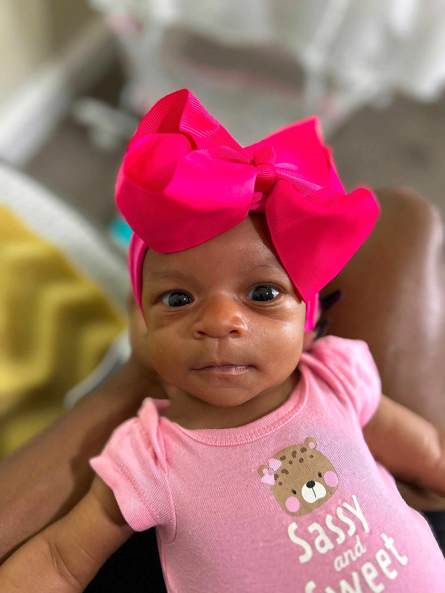 Talayah is registered to the contest to win money with this photo: baby, infant, pink_bow, headband, pink_onesie, sassy_and_sweet, close_up, portrait, cute, child, human, indoor, soft_focus, expression, looking_at_camera, skin, small_person, newborn, adorable, clothing