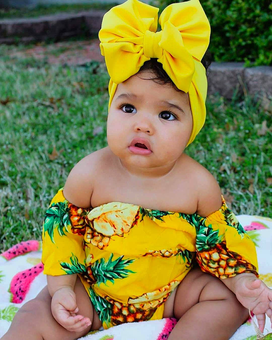 Avah is registered to the contest to win money with this photo: baby, baby_bloomers, baby_products, baby_toddler_clothing, child, clothing, costume_accessory, fashion_accessory, hair_accessory, headband, headgear, pattern, person, toddler, yellow