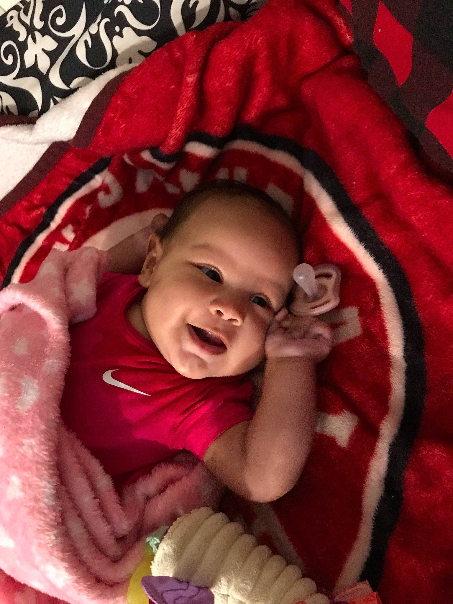 Zyanna is registered to the contest to win money with this photo: baby, baby_products, baby_toddler_clothing, bedding, carmine, cheek, child, comfort, event, happy, laugh, linens, magenta, pattern, person, pink, red, sleeve, smile, textile