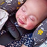 Esme is registered to the contest to win money with this photo: baby, sleeping, car_seat, child, infant, smile, rosy_cheeks, bandage, resting, face, head, clothing, patterned, seatbelt, comfort, cute, peaceful, floral_pattern, closeup, portrait