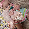Esme is registered to the contest to win money with this photo: baby, infant, pacifier, headband, stuffed_animal, blanket, crochet_blanket, pink, blue, pastel_colors, clothing, cute, lying_down, soft_toy, child, toddler, hand, face, comfort, cozy