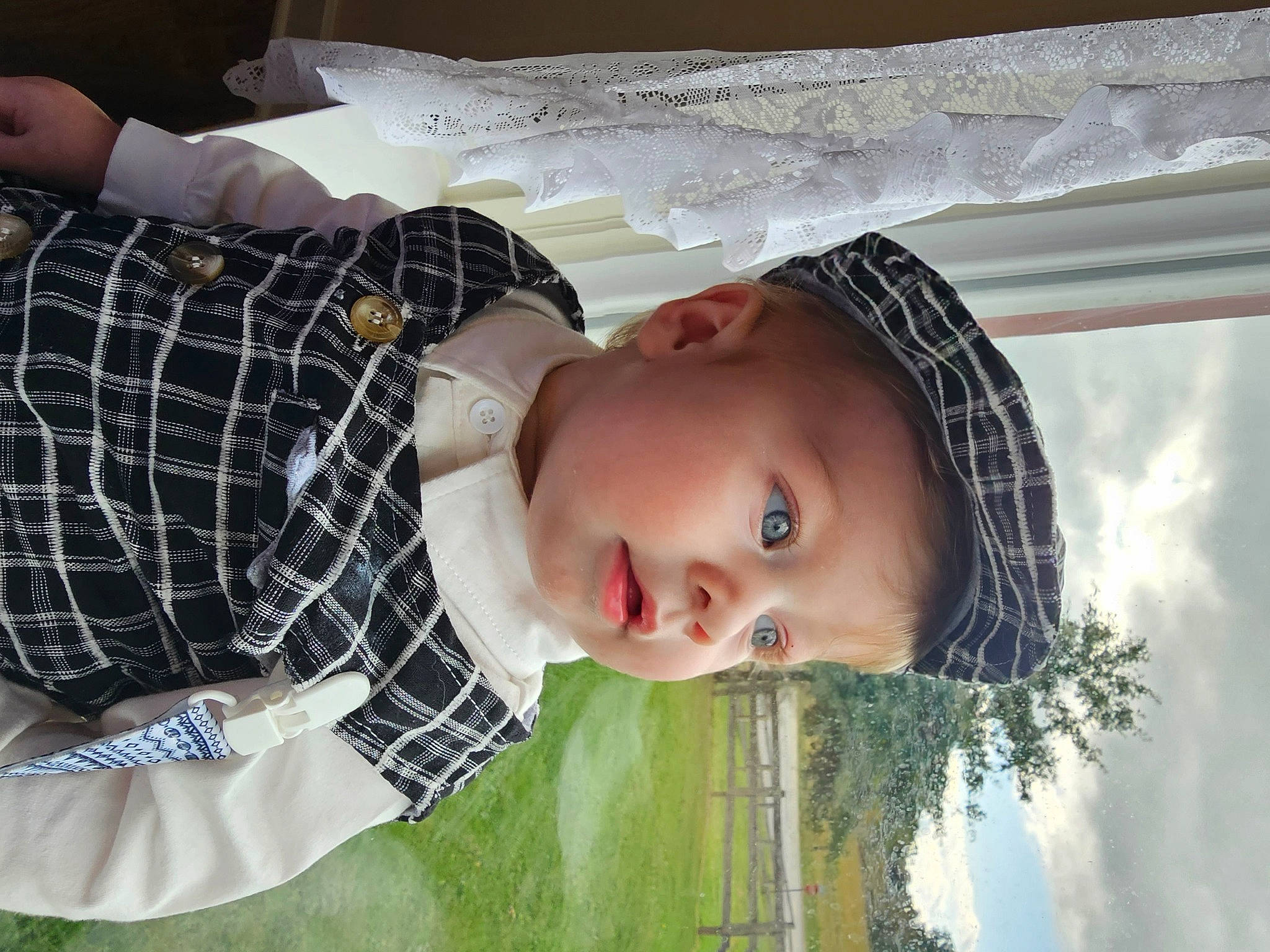Finnan is registered to the contest to win money with this photo: baby, child, cloud, flash_photography, fun, grass, happy, pattern, people_in_nature, person, plaid, plant, portrait_photography, sky, smile, tartan, toddler, tree, white, window