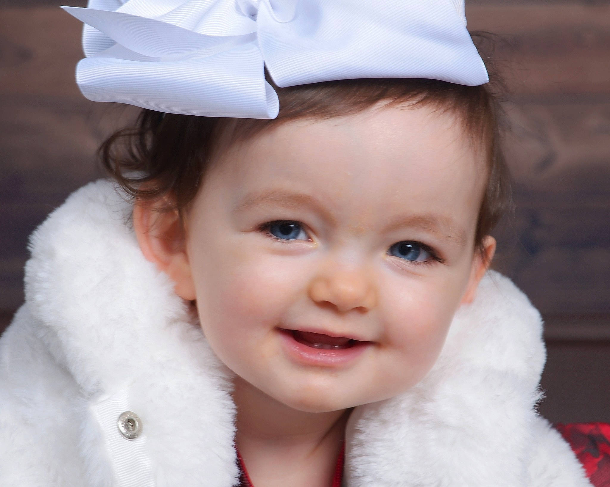 Harlow is registered to the contest to win money with this photo: baby, cap, cheek, child, child_model, ear, eye, face, facial_expression, fur, happy, head, headgear, joy, lip, nose, organ, outerwear, person, skin