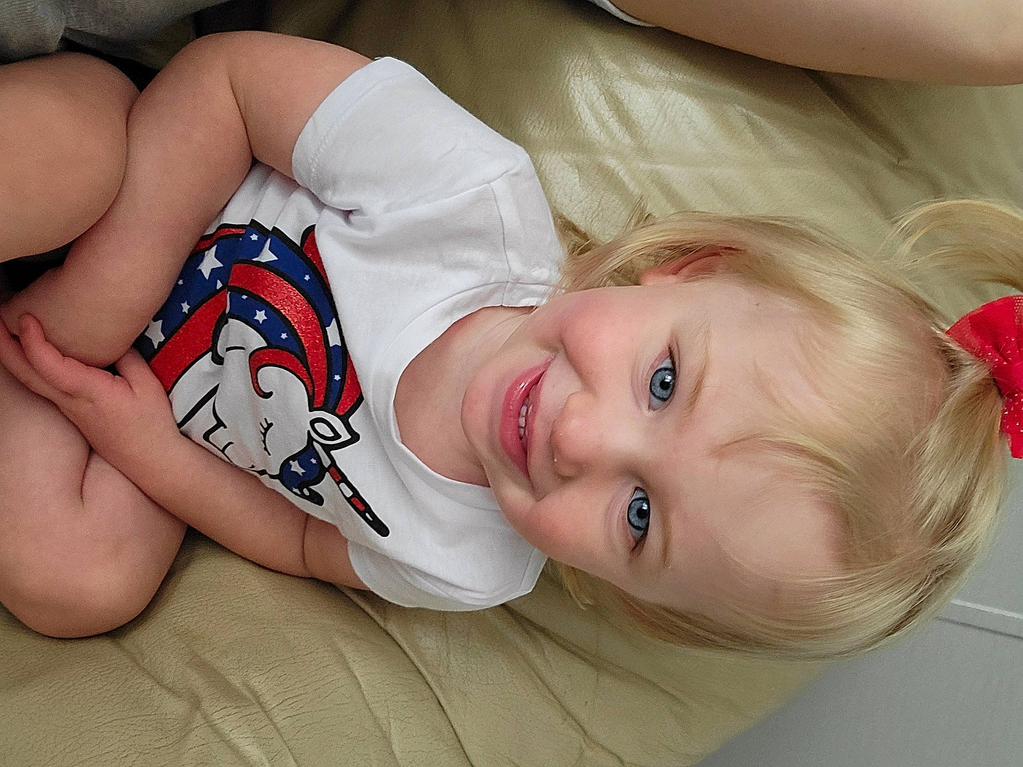 Madisyn is registered to the contest to win money with this photo: arm, baby_toddler_clothing, beauty, cheek, comfort, elbow, eye, eyelash, facial_expression, happy, human_leg, iris, joy, lip, mouth, neck, person, skin, sleeve, smile