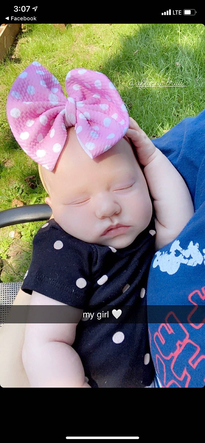Alana is registered to the contest to win money with this photo: baby, baby_toddler_clothing, beanie, blue, cap, child, fashion_accessory, glasses, grass, green, hand, hat, headband, magenta, pattern, person, pink, plant, sitting, sleeve