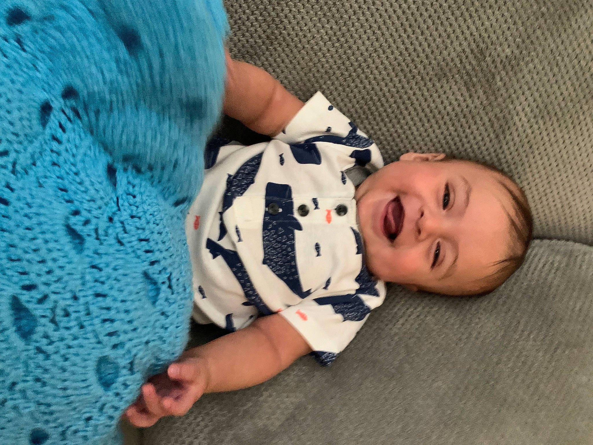 Joaquin is registered to the contest to win money with this photo: baby, baby_products, baby_toddler_clothing, child, comfort, electric_blue, finger, flooring, foot, hat, linens, nail, pattern, person, sitting, skin, sleeve, smile, textile, toddler