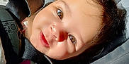 Harlow is registered to the contest to win money with this photo: baby, child, car_seat, sunlight, smile, face, brown_eyes, hair, happy, infant, seatbelt, closeup, portrait, safety, cute, skin, clothing, straps, car, young_child