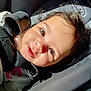 baby, child, car_seat, sunlight, smile, face, brown_eyes, hair, happy, infant, seatbelt, closeup, portrait, safety, cute, skin, clothing, straps, car, young_child