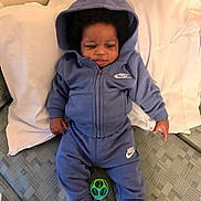 Kiari joined the competition — help win amazing prizes! baby, child, hoodie, blue_clothing, nike, pillow, mattress, toy, socks, indoor, infant, cute, young_child, casual_wear, relaxed, lying_down, curious, soft_lighting, home, portrait
