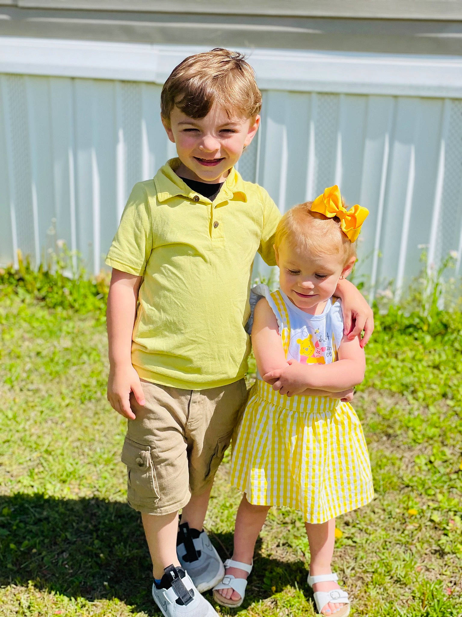 Harley is registered to the contest to win money with this photo: baby, baby_toddler_clothing, child, eye, face, fence, fun, gesture, grass, happy, head, interaction, joy, people, people_in_nature, person, pink, plant, skin, smile
