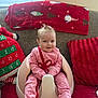 Lizzie joined the competition — help win amazing prizes! advent_calendar, baby, baby_seat, carpet, child, christmas_blanket, cozy, cute, face, festive, hair_clips, holiday_decor, home, indoors, infant, person, pink_clothing, red_pillow, sitting, smiling