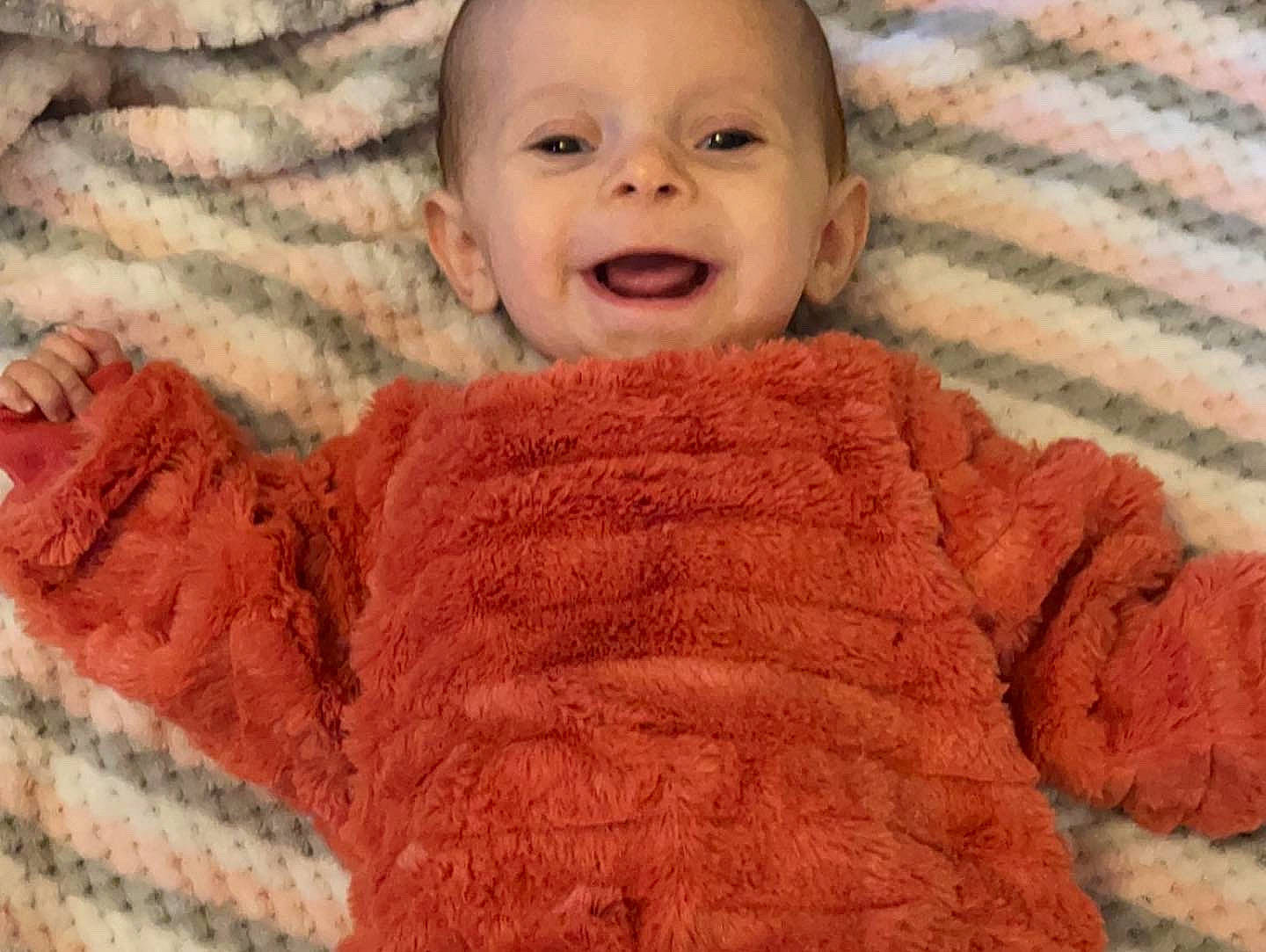 Ravyn is registered to the contest to win money with this photo: baby, baby_toddler_clothing, cheek, comfort, eye, face, finger, happy, head, headgear, nose, organ, outerwear, pattern, person, skin, sleeve, smile, textile, toddler