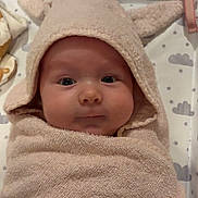 Poppy joined the competition — help win amazing prizes! baby, infant, towel, hooded_towel, wrapped, cute, face, eyes, blanket, cloud_pattern, star_pattern, soft_texture, child, indoors, lying_down, plush, newborn, skin, expression, cozy