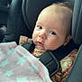 Poppy is registered to the contest to win money with this photo: baby, infant, car_seat, blanket, pink, stars, child, face, portrait, blue_eyes, clothing, safety_harness, seatbelt, cute, indoors, soft_light, young_child, head_support, car_interior, expression