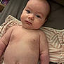 baby, infant, diaper, bed, blanket, clothing, lying_down, indoors, skin, face, arms, torso, expression, soft, sleepwear, comfort, newborn, cute, chubby, child